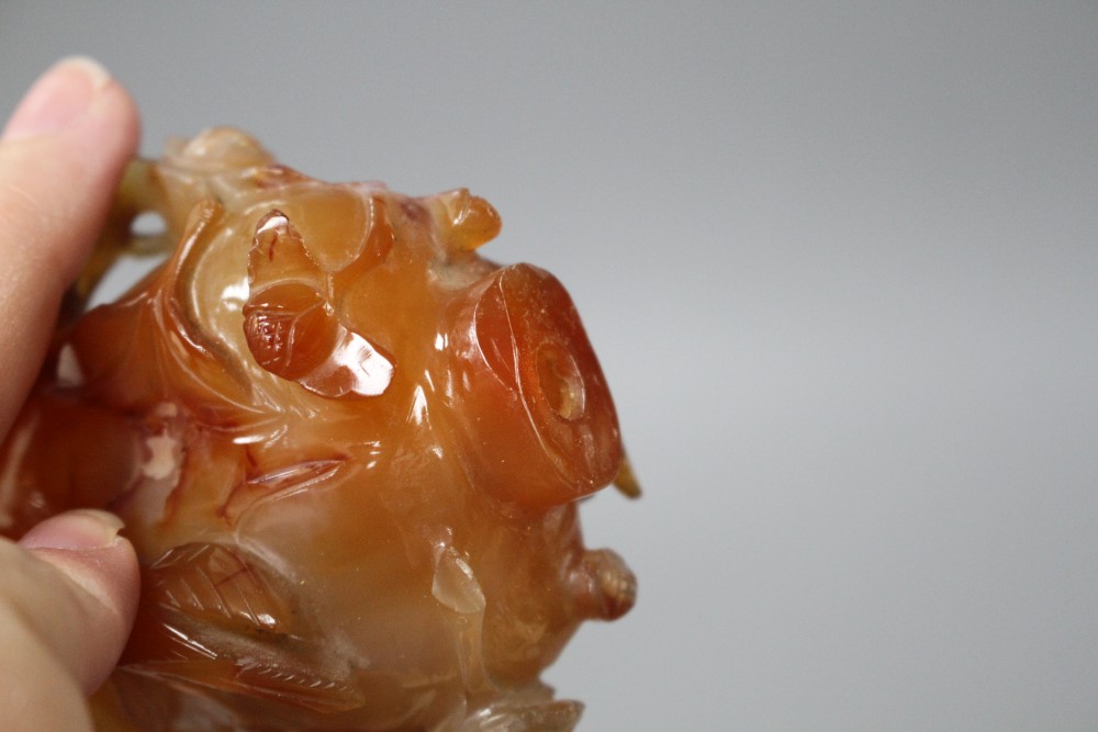 A Chinese orange agate snuff bottle and stopper, carved in relief with birds and flowers, width 6cm, height 8.5cm